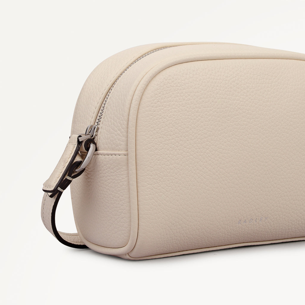 THE DAILY SMALL ZIP AROUND CROSS BODY SALT