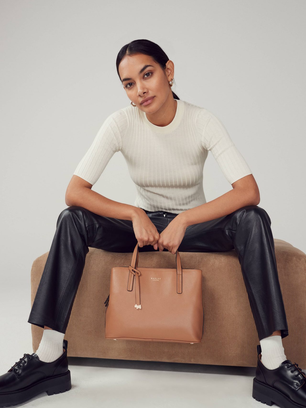 Model with two Dukes Place leather handbags